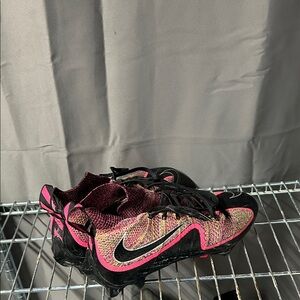 Pink and black football cleats untouchables